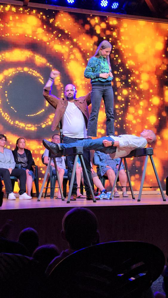 a man standing on a stage with a woman on stage