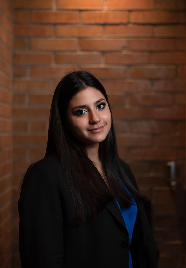 a woman in a black jacket and blue top