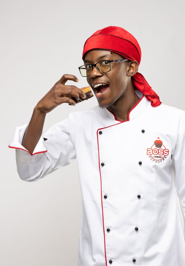 a man in a chef's uniform is holding a cookie