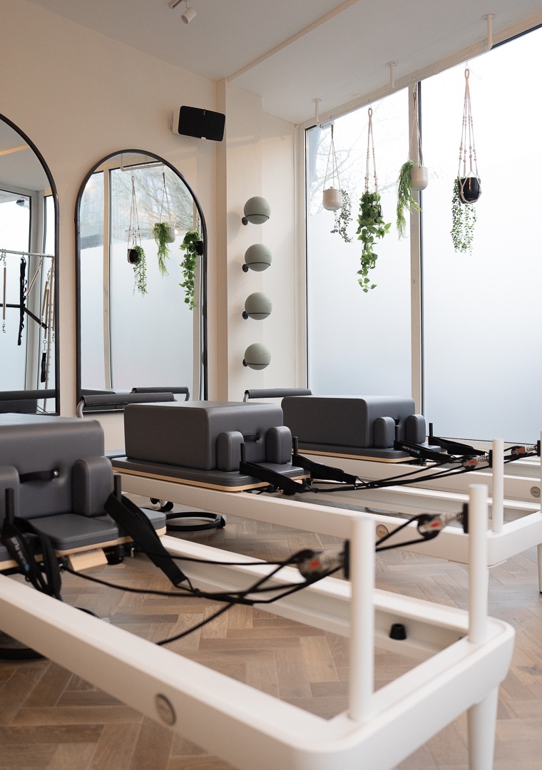 reformer pilates with mirrors and flowers