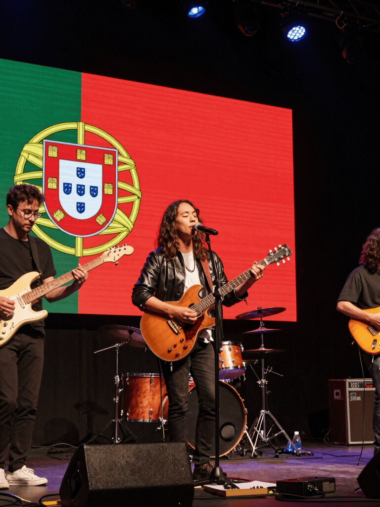A lively crowd enjoying a vibrant event under string lights, capturing joyful moments.
