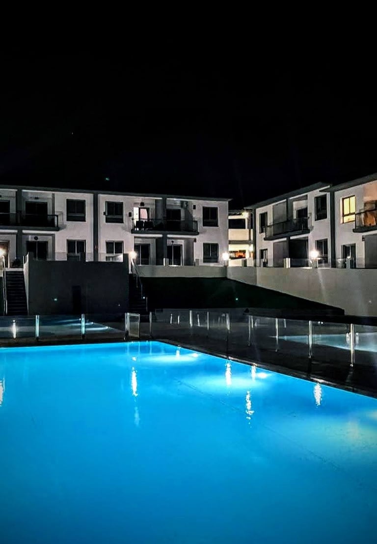 a pool with a pool and a waterfall in the background
