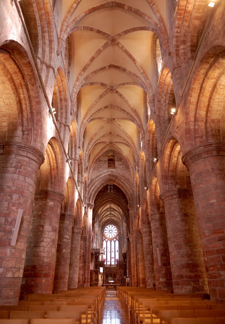 a church with a large stone vaulted ceiling and a church pew area