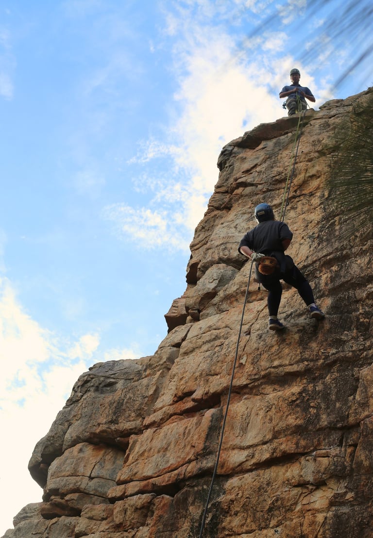 Participants abseiling down a sheer cliff during a half-day adventure at Morialta Conservation Park,