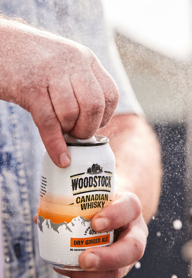Product photography - a man holding a can of woodstock