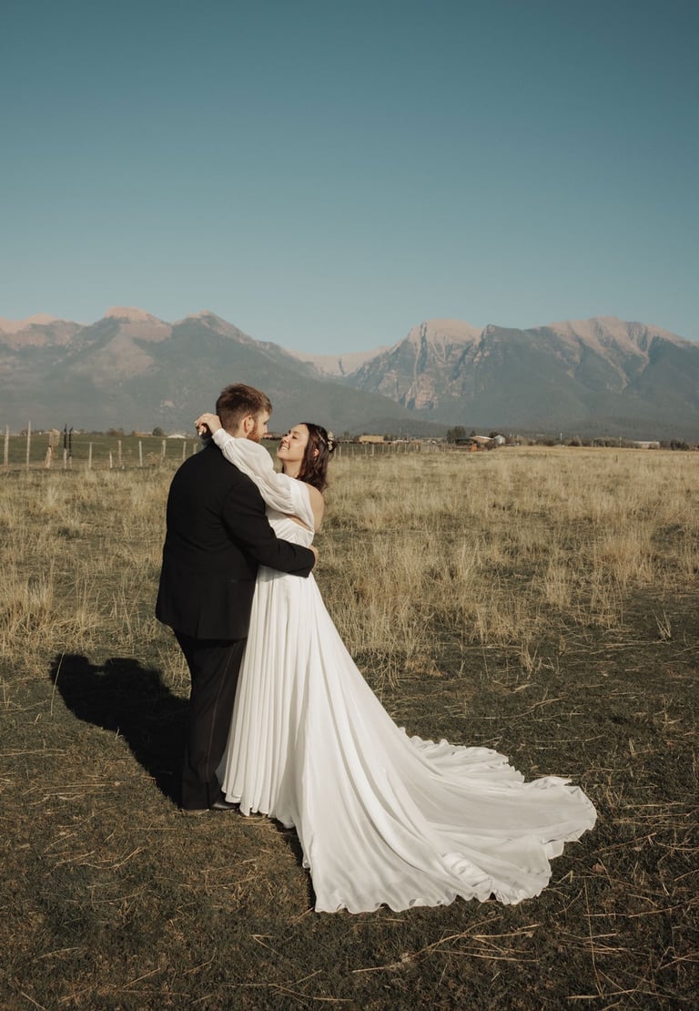 bride and groom portrait in a field, Montana mountains