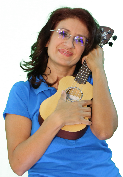 a woman in glasses and a blue shirt holding a ukulele