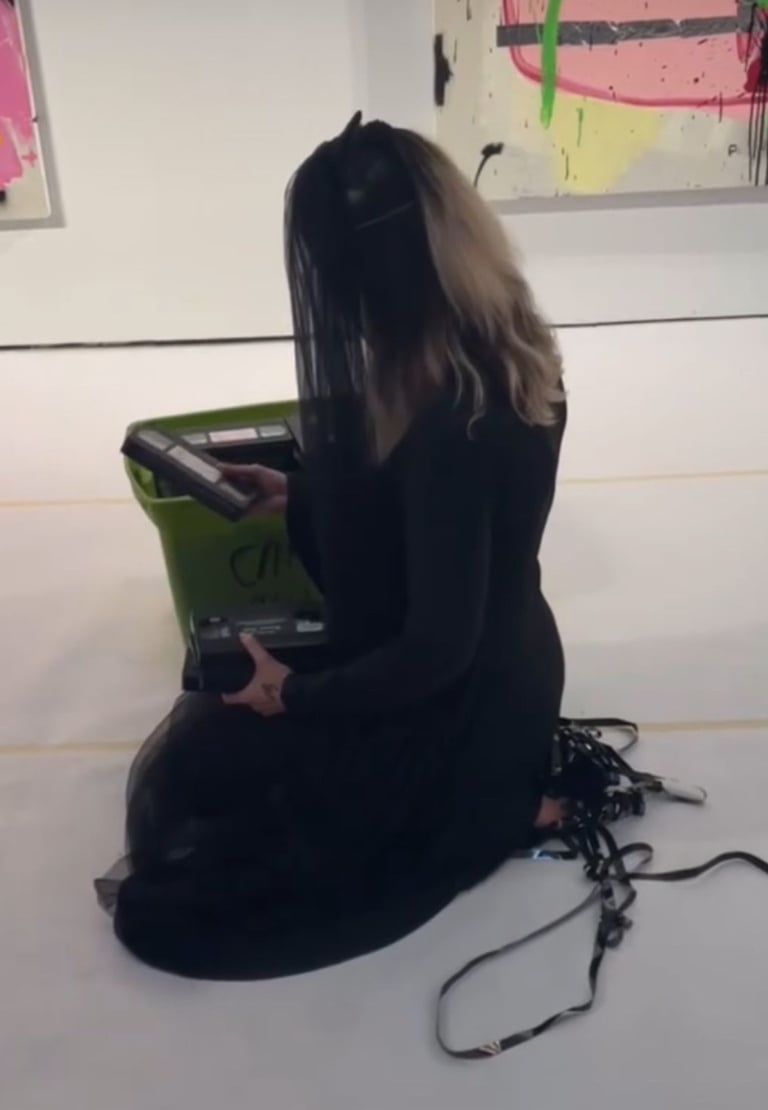 contemporary performance artist lvf.lvx pulling out vhs tapes in ritual performance tapes in drag