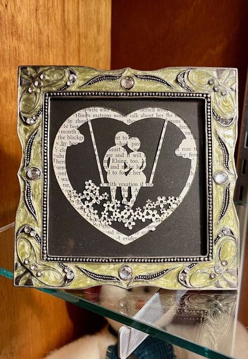 laser engraved layered paper silhouette of couple on a swing