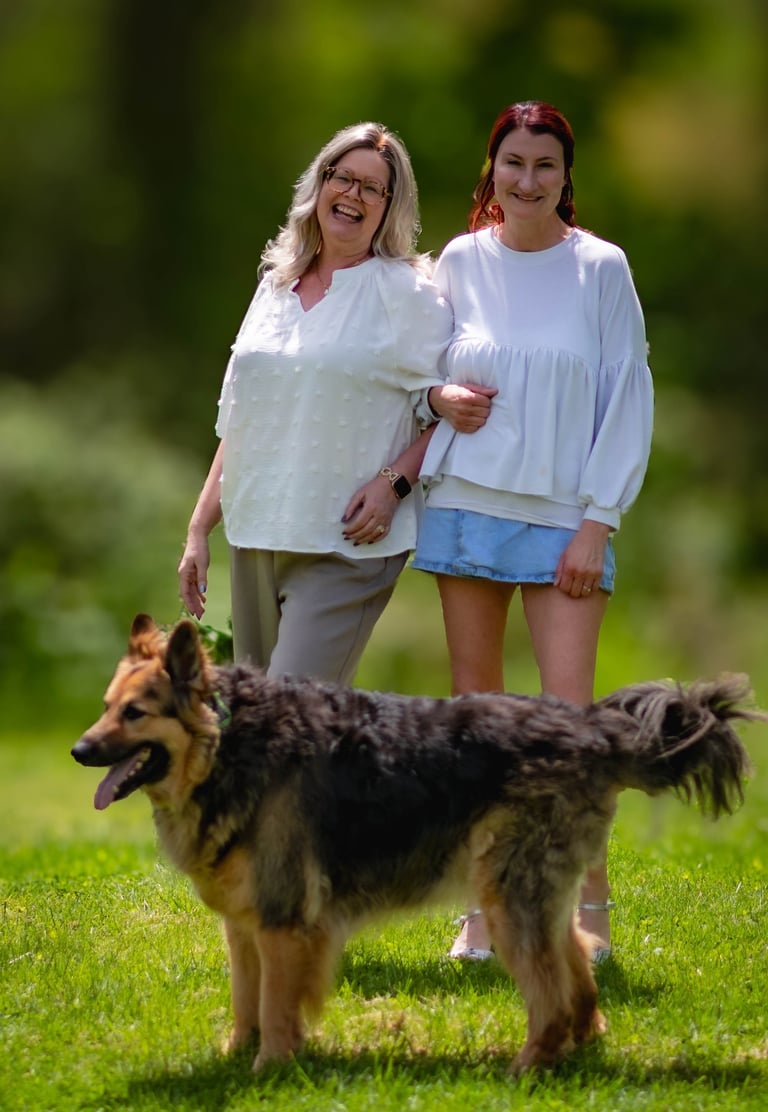This image portrays a warm, candid moment outdoors featuring two people walking arm in arm. Athens