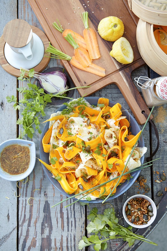 a plate of pasta with vegetables and sauce