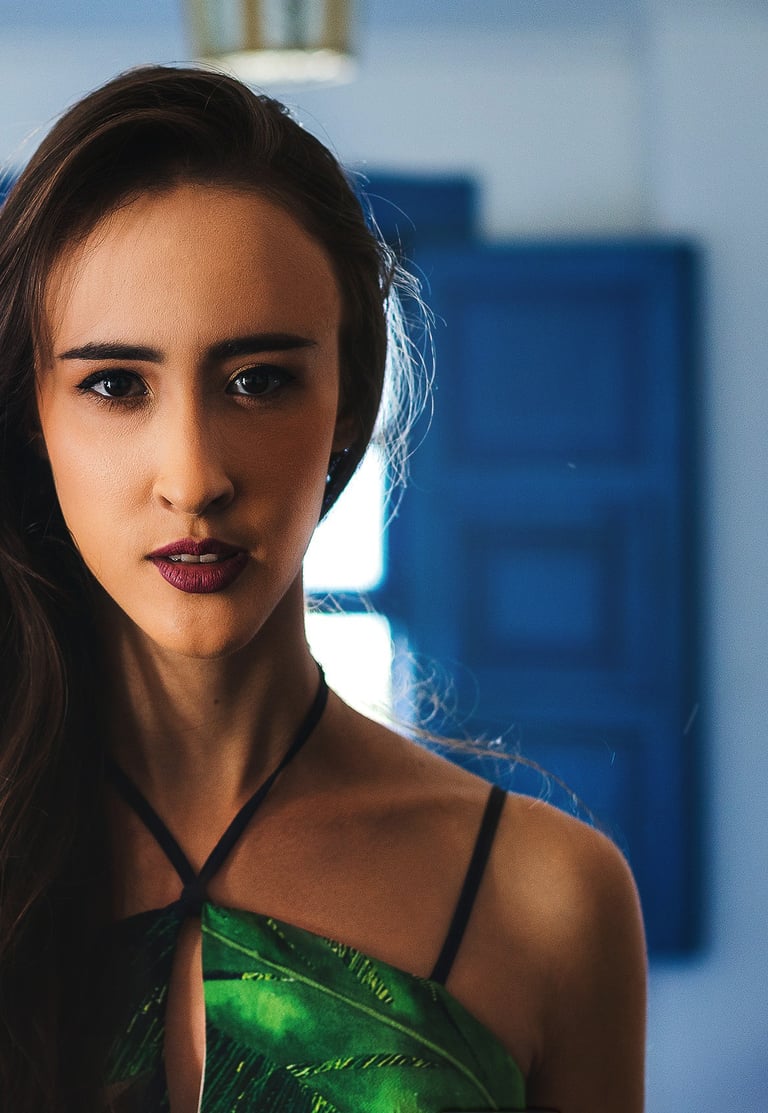 Fashion-inspired portrait of a woman in green with dramatic indoor lighting
