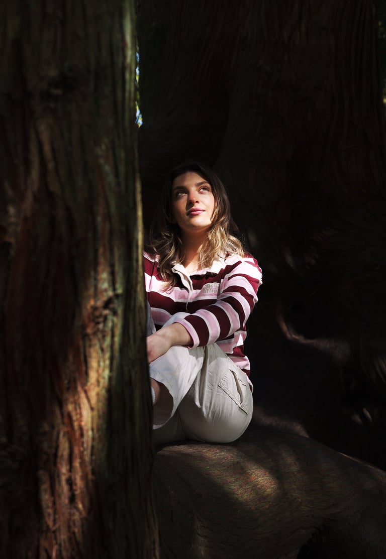 Fine art portrait of a young woman looking toward the light in a cinematic style