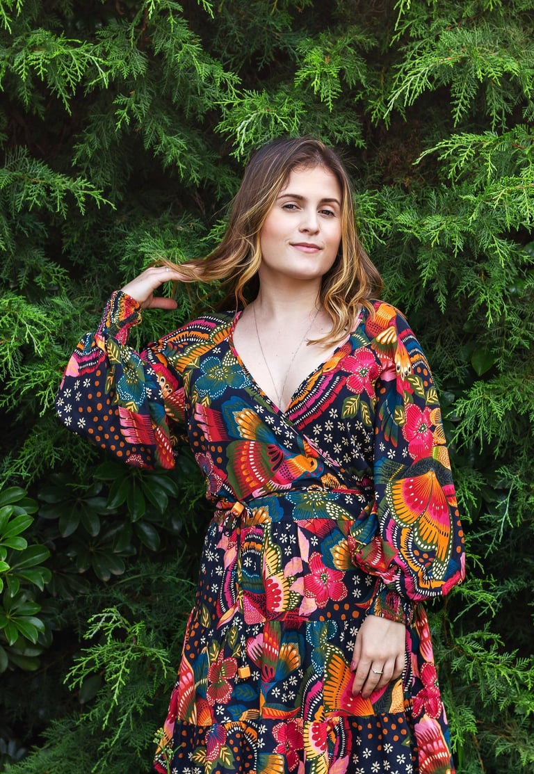Fashion-inspired outdoor portrait of a woman in a vibrant floral dress