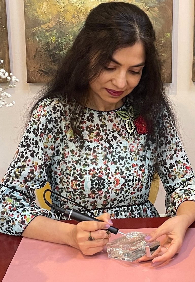 Radhika, artist behind Bella Calligraphy engraving a perfume bottle