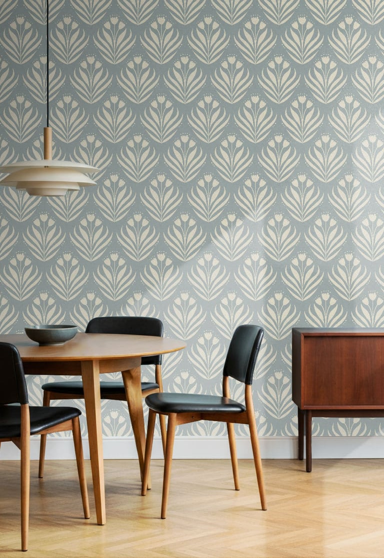Soft blue and cream botanical wallpaper with an elegant tulip motif, styled in a modern dining room