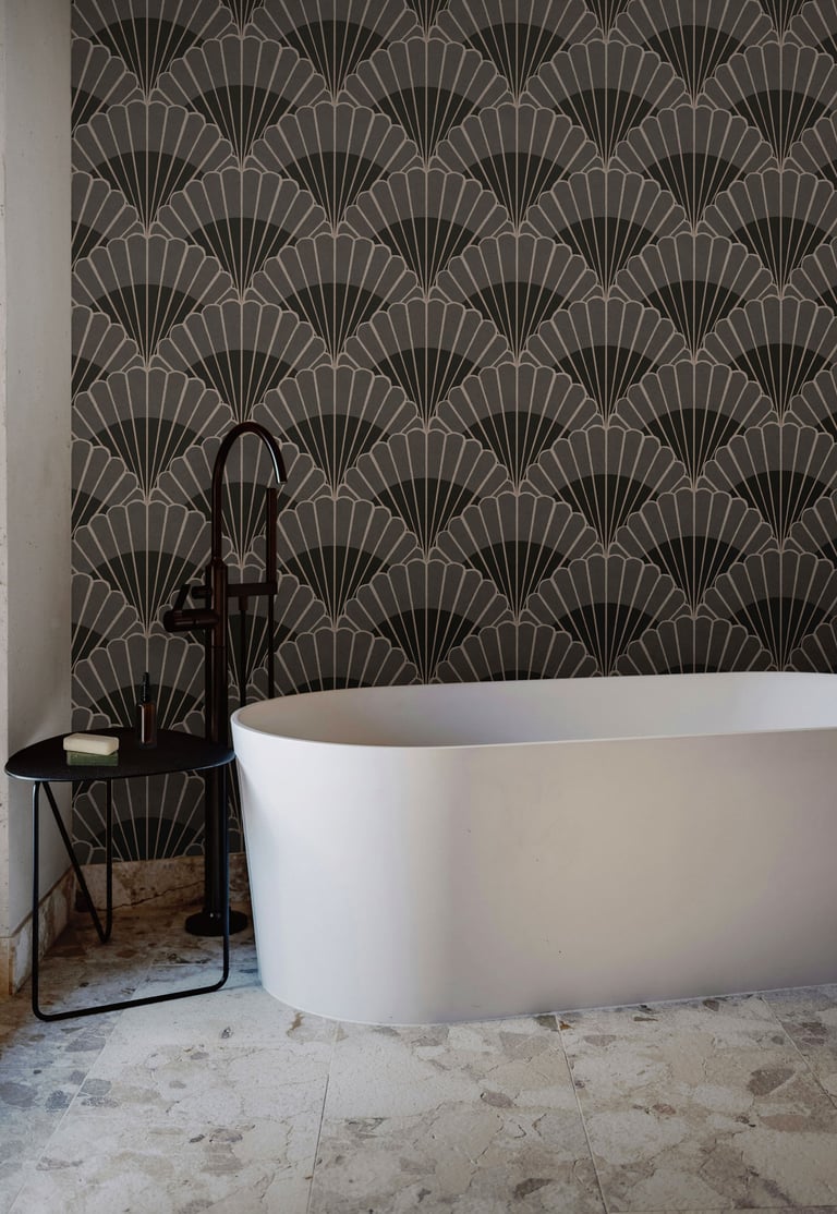 Charcoal and grey Art Deco wallpaper with bold fan motifs, styled in a modern bathroom with a freest