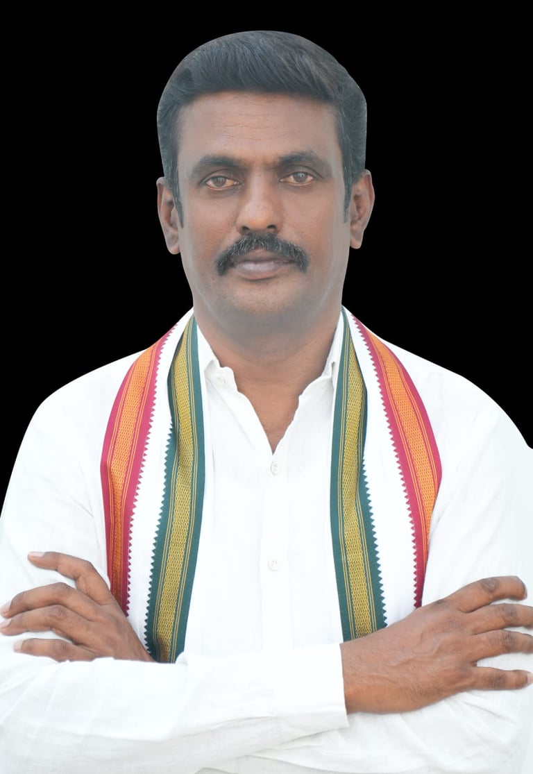 A portrait of an Indian politician with a mustache, wearing a white shirt and a traditional tricolor stole.