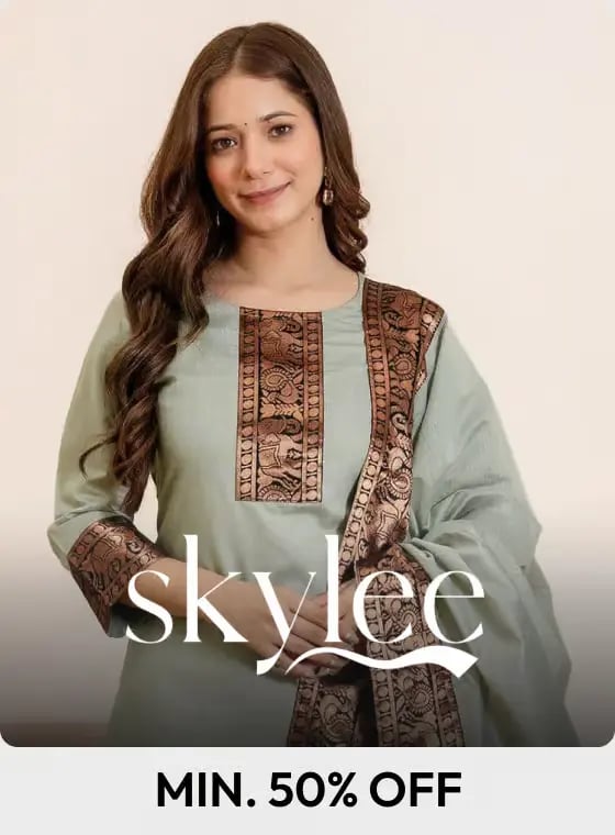 Woman wearing a light green Skylee brand ethnic kurti set with bronze embroidered borders and dupatta.