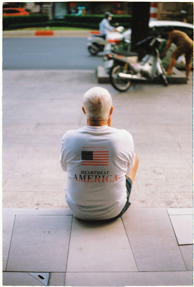 Vietnamese man sit on the pavement is Saigon China town shot on film