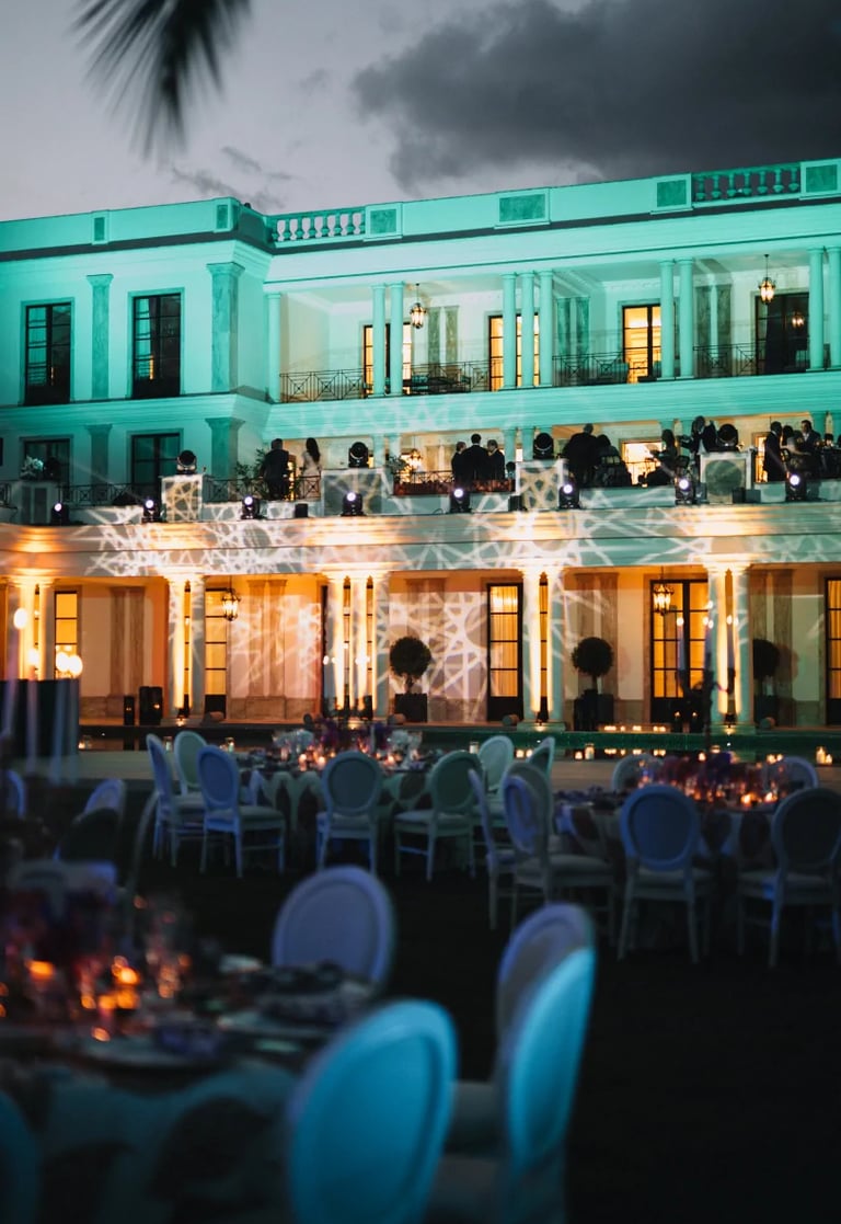 Evening reception in front of illuminated villa façade