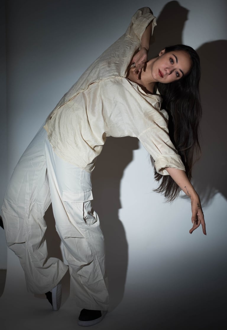 a woman in white pants and a white shirt
