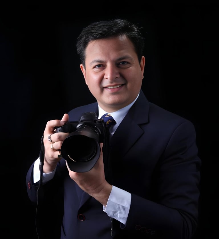 a man in a suit and tie is holding a camera