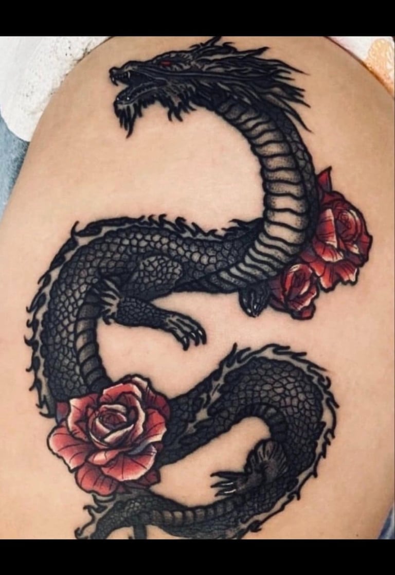 Detailed black ink Japanese dragon tattoo with vibrant red roses on skin.