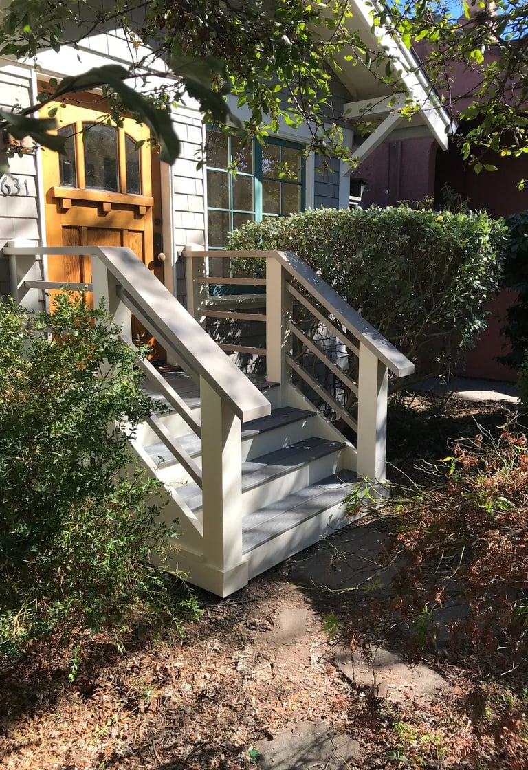 a house with a wooden deck and stairs
