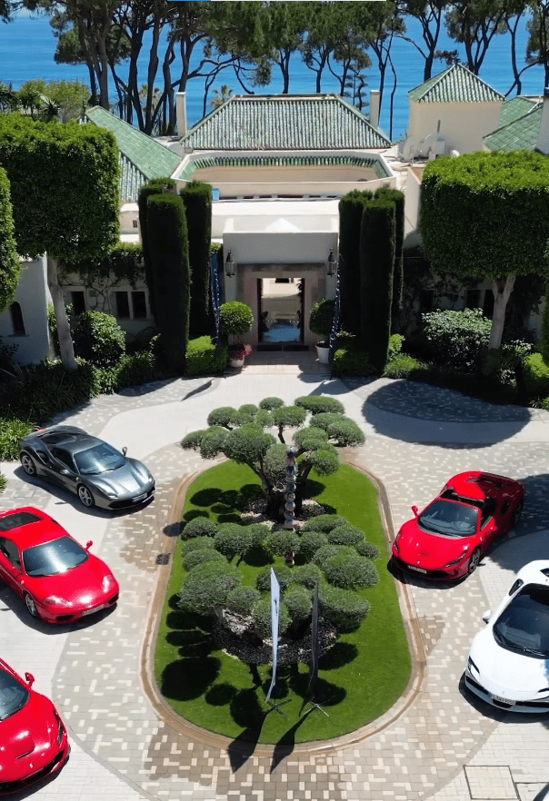 Corporate event at Villa El Rincon featuring luxury sports cars displayed in the courtyard