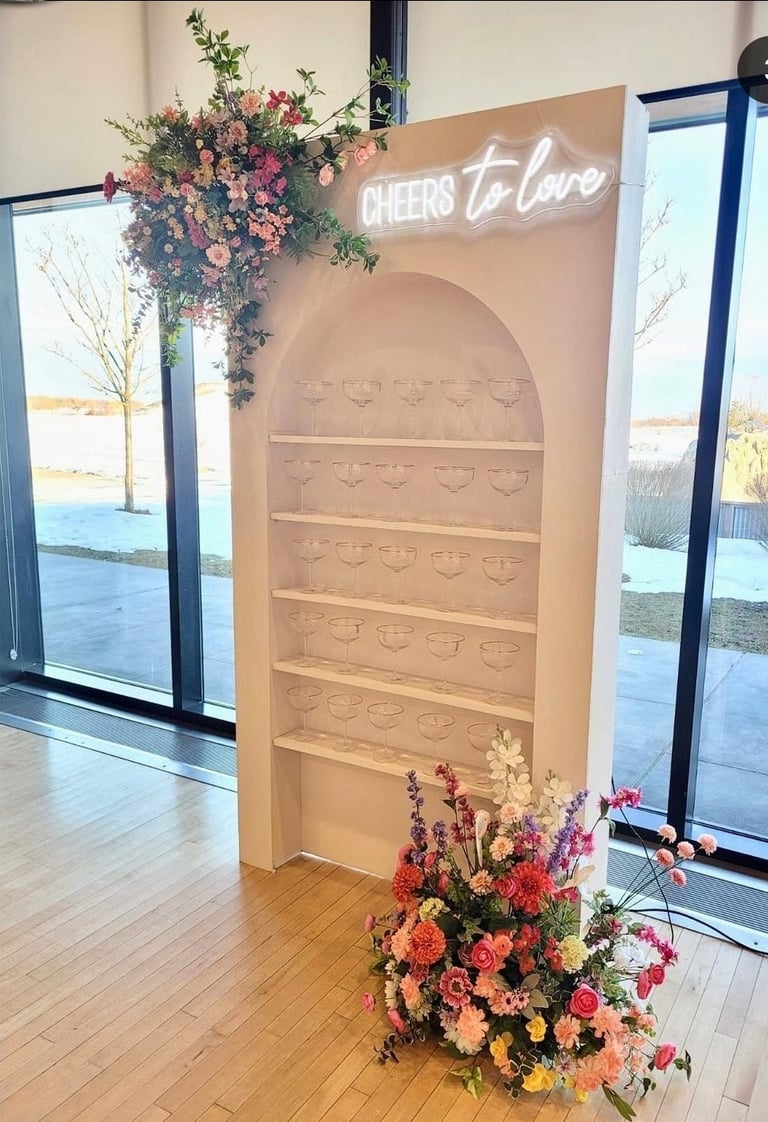 Champagne wall arch with sping flowers, champagne couples and spring flowers