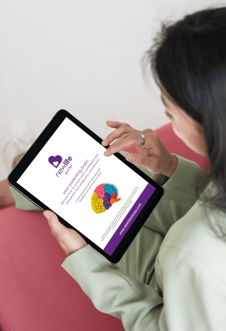 a woman holding a tablet and reading the new life guide - your parenting brain