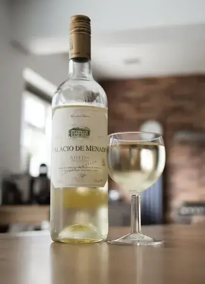 a BOTTLE of wine and a glass of wine