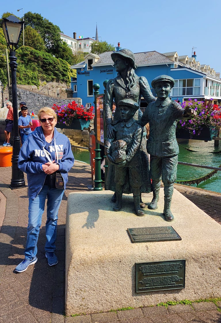 Lady at Annie Moore Statue in Cobh, Ireland