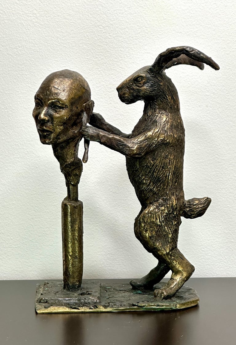 a statue of a rabbit sculpting a human head