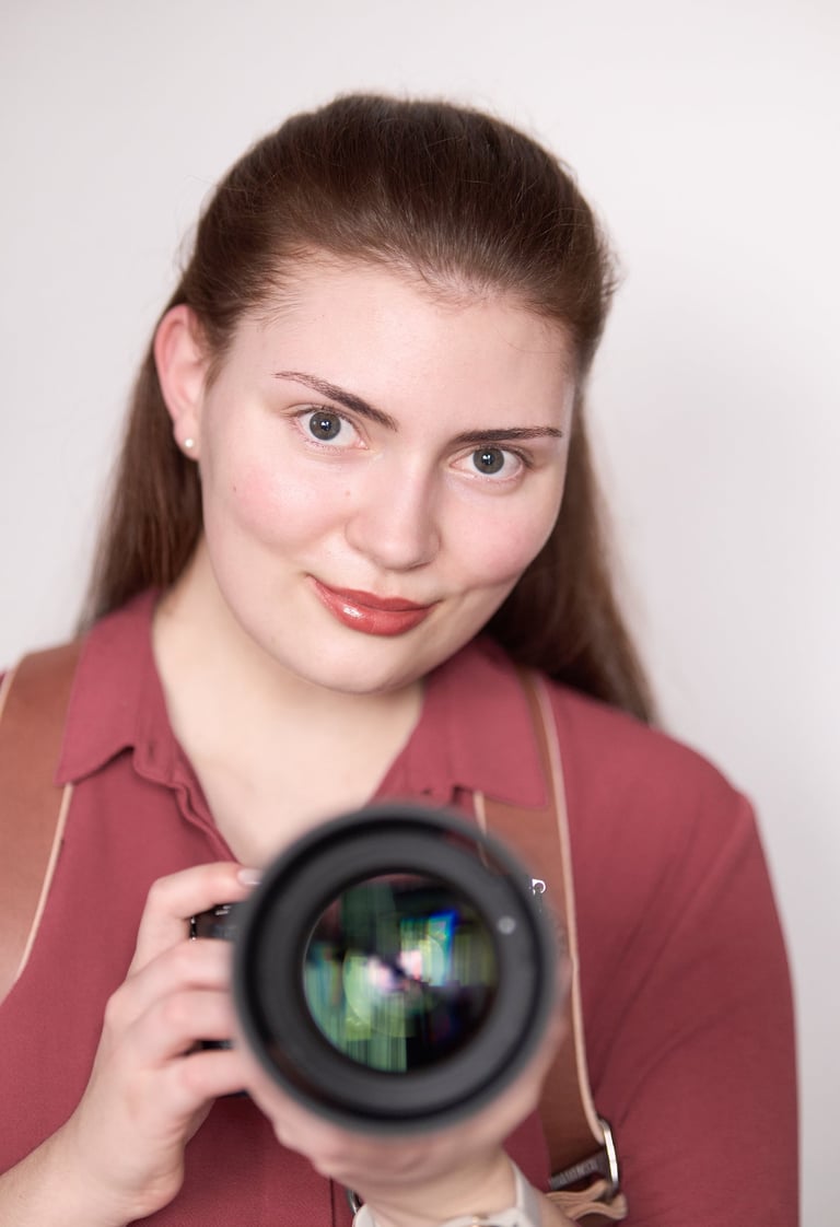 a woman holding a camera and taking a picture