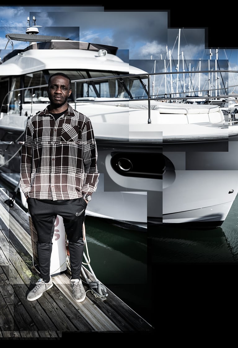 A photo joiner of Ini standing next to a yacht