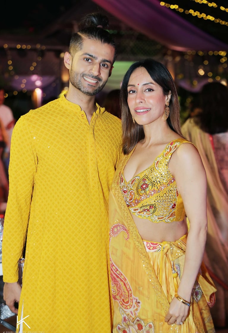 a man and woman in yellow clothes standing next to each other