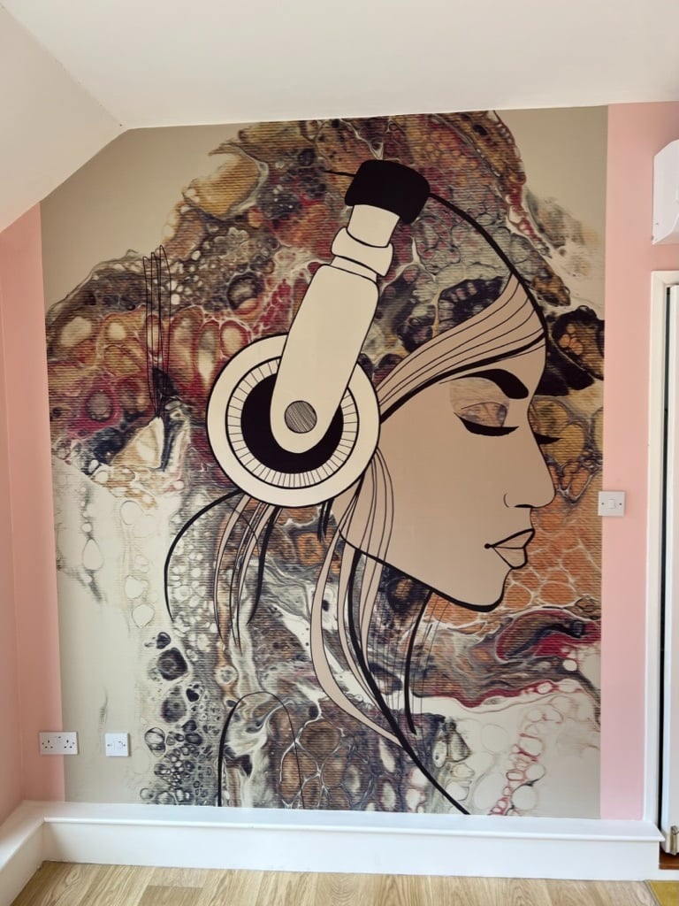 Feature wall wallpaper installation with bespoke mural and wood flooring in a Brighton home