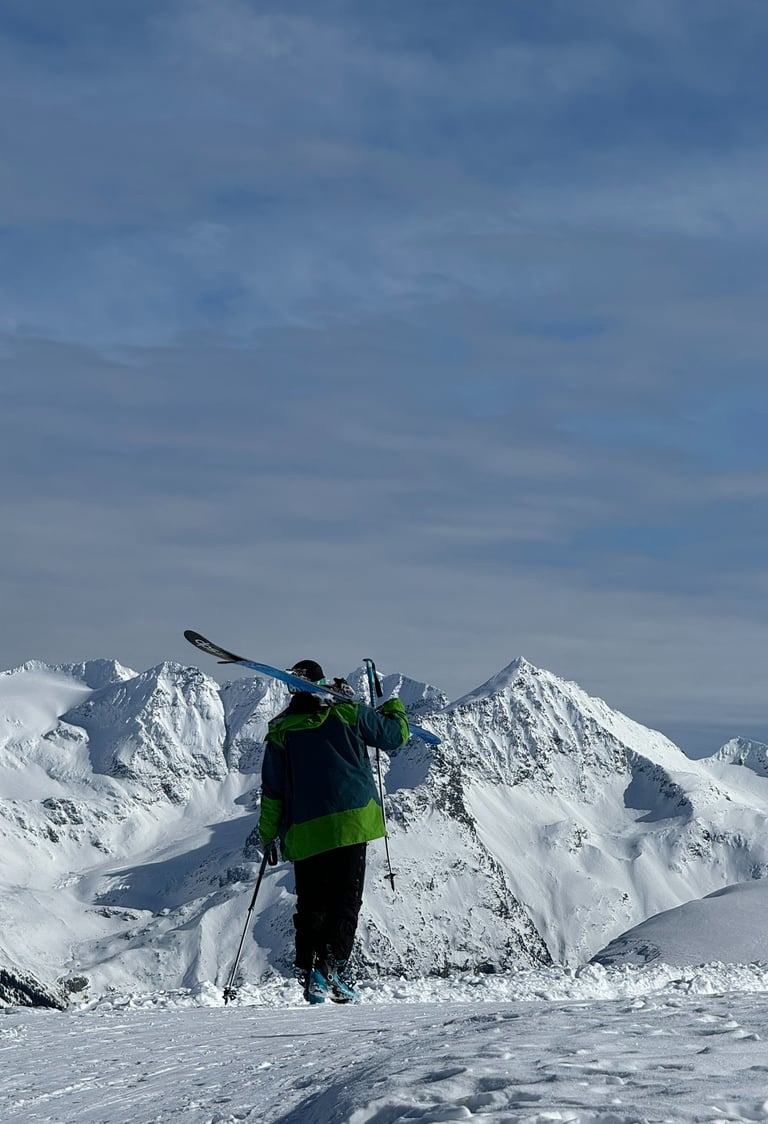 a person standing on a snowy mountain top