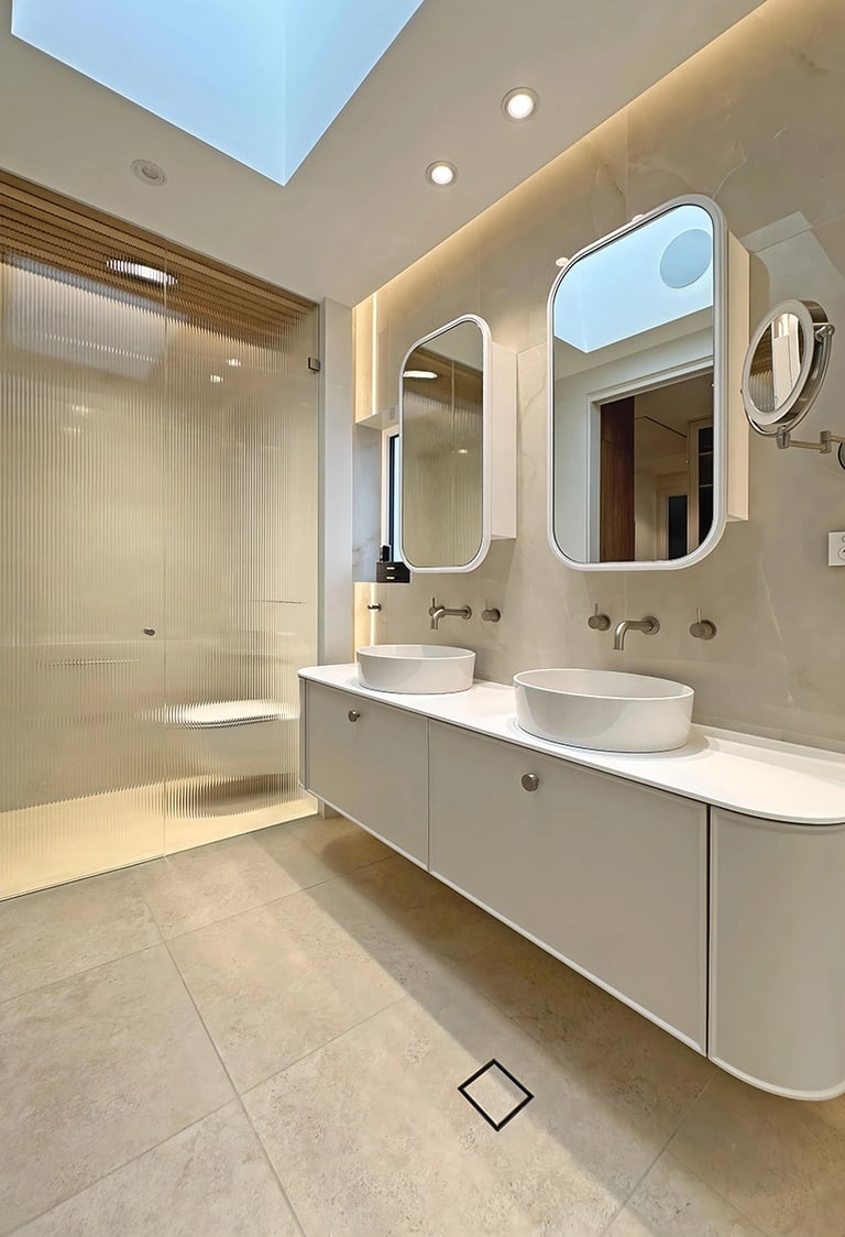luxury master ensuite renovation in Mosman with freestanding tub, fluted glass partitions, and oak-lined ceiling
