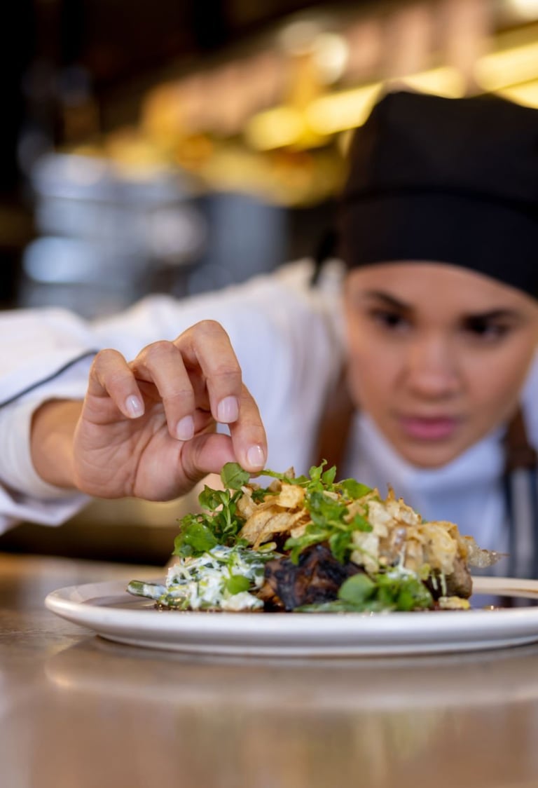 a chef is preparing to serve a meal