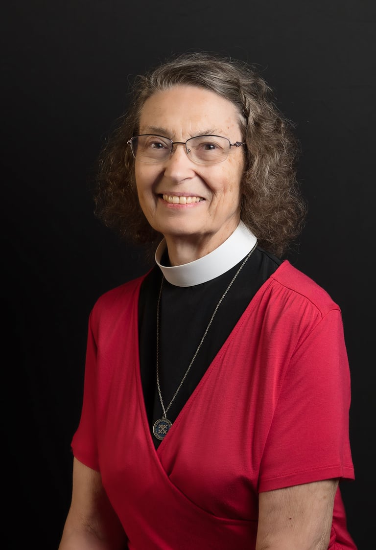 a woman in a red dress and glasses wearing a necklace