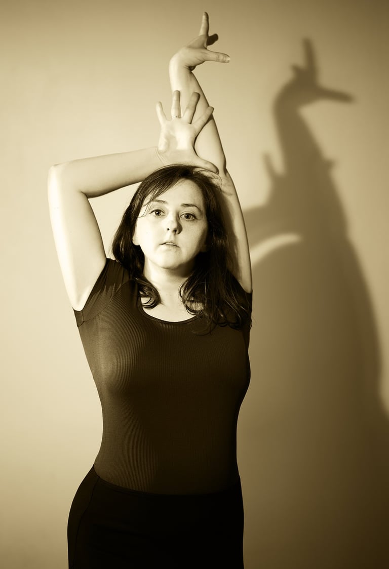 a woman in a dress and a shadow in the background with sepia style