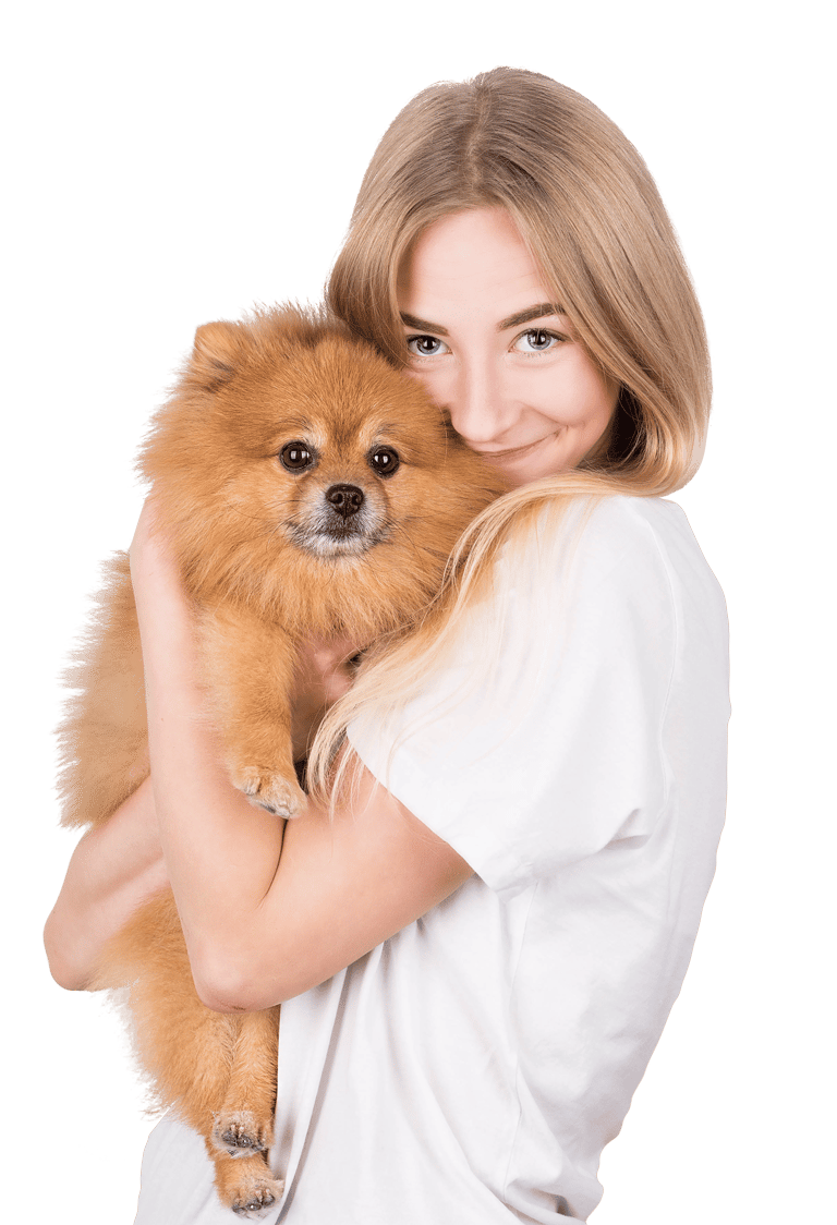 A smiling blonde woman lovingly hugs a fluffy, orange Pomeranian dog.