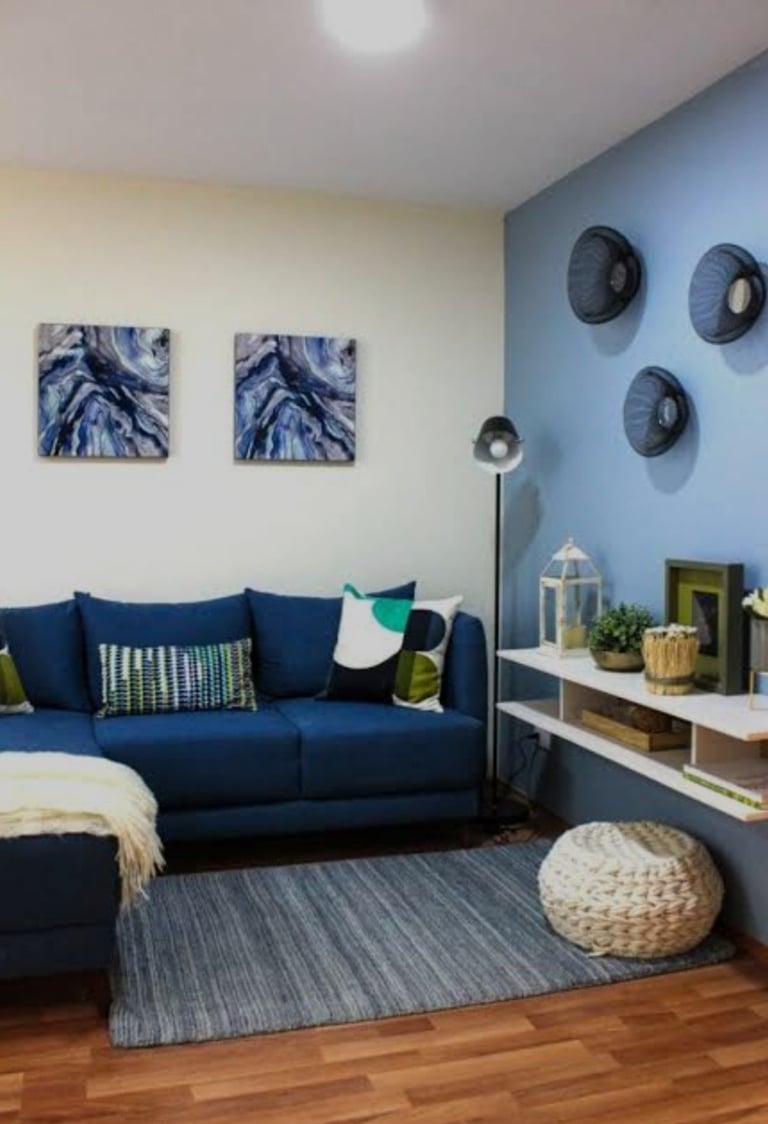 Interior de sala en departamento muestra general, CDMX. Sofá en tonos azules, decoración moderna