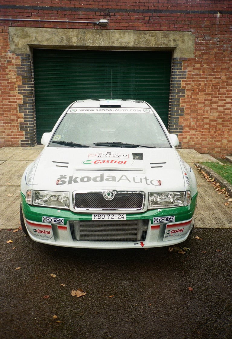 a rally car parked in front of a garage