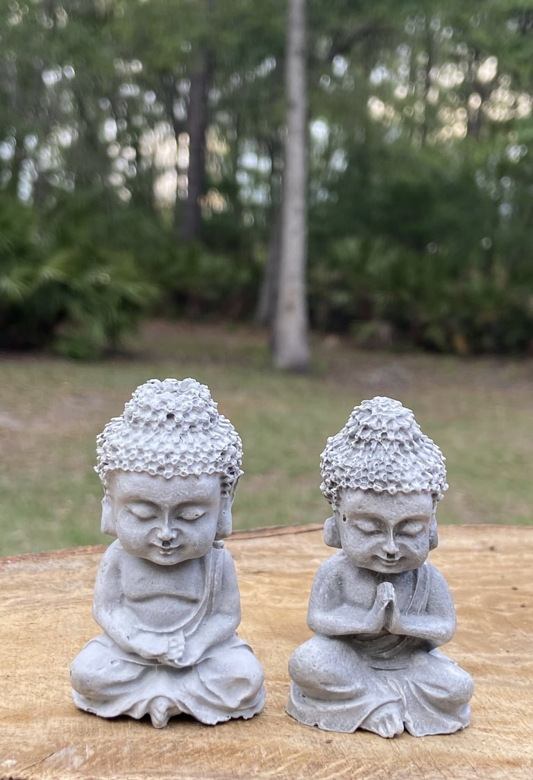 Two small stone Buddha statues.