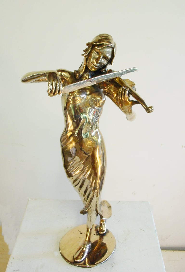 a statue of a woman playing the violin