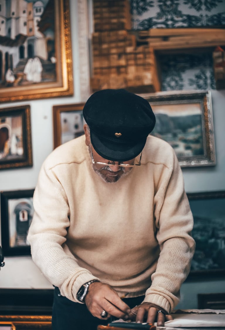 a man in a hat and a hat on a table